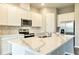 Kitchen island with quartz countertop, stainless steel appliances and marble backsplash at 16271 Silver Grove Blvd, Winter Garden, FL 34787