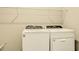 Laundry room features modern Whirlpool washer and dryer beneath wire shelving at 16271 Silver Grove Blvd, Winter Garden, FL 34787