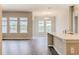 Open-concept living room with hardwood floors, large windows, and modern lighting at 16271 Silver Grove Blvd, Winter Garden, FL 34787