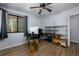 Bedroom featuring light gray walls, ceiling fan, hardwood floors, and home office setup at 1635 Magnolia Ave, South Daytona, FL 32119