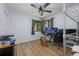 Bedroom featuring light gray walls, ceiling fan, hardwood floors, and home office setup at 1635 Magnolia Ave, South Daytona, FL 32119