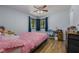 Bright bedroom with ceiling fan, two windows, hardwood floor and desk for working at 1635 Magnolia Ave, South Daytona, FL 32119