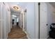 Hallway with hardwood floors and white doors that lead to various rooms in the house at 1635 Magnolia Ave, South Daytona, FL 32119