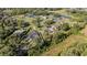 Panoramic aerial perspective of residential properties bordered by lush woods and a tranquil lake community at 1651 Big Oak Ln, Kissimmee, FL 34746