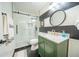 Stylish bathroom with a glass-enclosed shower, modern fixtures, and a black and white accent wall at 1651 Big Oak Ln, Kissimmee, FL 34746