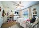 A charming bedroom with natural light, a ceiling fan, and unique decor at 1651 Big Oak Ln, Kissimmee, FL 34746