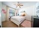 Bright bedroom with a white bed, pink accents, and wood flooring; perfect for a  at 1651 Big Oak Ln, Kissimmee, FL 34746