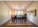 Bright dining room featuring a large table with seating for eight and a modern light fixture at 1651 Big Oak Ln, Kissimmee, FL 34746