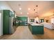 Spacious kitchen featuring an island with seating, stainless appliances, and open layout to living area at 1651 Big Oak Ln, Kissimmee, FL 34746