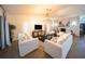 Spacious living room with high ceilings, brick fireplace, elegant chandelier, and bright natural light at 1651 Big Oak Ln, Kissimmee, FL 34746