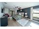 Comfortable main bedroom featuring wood flooring, a ceiling fan, and an elegant dark accent wall at 1651 Big Oak Ln, Kissimmee, FL 34746