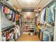 Well-organized walk-in closet with racks, shelves, and a variety of clothing and shoes at 1651 Big Oak Ln, Kissimmee, FL 34746