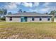 A spacious backyard with a sliding glass door, windows, and healthy green grass at 16771 Sw 21St Terrace Rd, Ocala, FL 34473