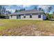 The backyard has a large grassy area and a sliding glass door leading inside the home at 16771 Sw 21St Terrace Rd, Ocala, FL 34473