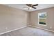 Small bedroom with neutral walls, carpet, a ceiling fan, and a window at 16771 Sw 21St Terrace Rd, Ocala, FL 34473