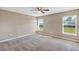 Neutral bedroom with carpet, large windows, base trim, and lots of sunlight at 16771 Sw 21St Terrace Rd, Ocala, FL 34473