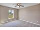 Bedroom with carpet, neutral walls, a window overlooking the yard, and ceiling fan at 16771 Sw 21St Terrace Rd, Ocala, FL 34473