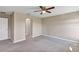 Spacious bedroom with neutral walls, carpet, ceiling fan, and white trim at 16771 Sw 21St Terrace Rd, Ocala, FL 34473