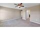 Large bedroom features neutral walls, carpet, ceiling fan, and closet entrance at 16771 Sw 21St Terrace Rd, Ocala, FL 34473