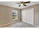 Bedroom with neutral walls, carpet, a ceiling fan, a window, and a closet at 16771 Sw 21St Terrace Rd, Ocala, FL 34473