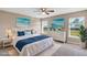 Staged bedroom with a ceiling fan, two windows, carpet flooring, and neutral decor at 16771 Sw 21St Terrace Rd, Ocala, FL 34473