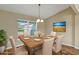 Formal dining room with a wood table set for six, complemented by natural light from a large window at 16771 Sw 21St Terrace Rd, Ocala, FL 34473