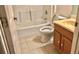 Bathroom featuring a toilet, combination tub and shower and vanity with sink at 1805 San Luis Ln, The Villages, FL 32159