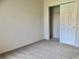 Bedroom with neutral walls, carpeted floor, and a closet with sliding doors at 1805 San Luis Ln, The Villages, FL 32159