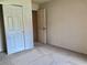 Bedroom with neutral walls, carpeted floor, and closets with sliding doors at 1805 San Luis Ln, The Villages, FL 32159