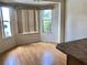 Dining room featuring laminate floors, multiple windows, and light fixtures at 1805 San Luis Ln, The Villages, FL 32159