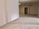 Open living room with neutral carpet and a view of an arched doorway at 1805 San Luis Ln, The Villages, FL 32159