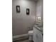 Updated half bath featuring a granite vanity top, new fixtures, and a decorative mirror at 2013 Sarazen Ct, Orlando, FL 32808