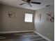 Bedroom with wood-look flooring, a ceiling fan, and neutral wall paint at 2013 Sarazen Ct, Orlando, FL 32808