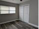 Bedroom featuring updated flooring, neutral walls, and a closet with folding doors at 2013 Sarazen Ct, Orlando, FL 32808