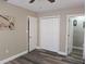 Bedroom with wood-look flooring and doors leading to the closet and bath at 2013 Sarazen Ct, Orlando, FL 32808
