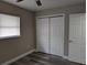 Bedroom featuring updated flooring, closet, neutral walls, and a ceiling fan at 2013 Sarazen Ct, Orlando, FL 32808