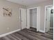 Bright bedroom with wood-look flooring, closet, and adjoining bathroom at 2013 Sarazen Ct, Orlando, FL 32808