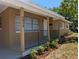 Welcoming front porch with black railing, landscaping, and view of the home's exterior features at 2013 Sarazen Ct, Orlando, FL 32808