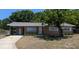 Charming single-story home with a well-maintained lawn and mature tree in the front yard at 2013 Sarazen Ct, Orlando, FL 32808