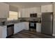 Contemporary kitchen showcasing stainless steel appliances, granite counters, and bright white cabinetry at 2013 Sarazen Ct, Orlando, FL 32808
