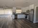 Modern kitchen featuring stainless steel appliances, granite countertops, and new flooring at 2013 Sarazen Ct, Orlando, FL 32808
