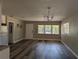Well-lit living room featuring new flooring, neutral color palette, and a clear view to the kitchen at 2013 Sarazen Ct, Orlando, FL 32808