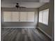 Spacious living room with updated flooring, neutral walls, and a ceiling fan at 2013 Sarazen Ct, Orlando, FL 32808