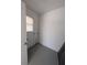 White storage room with single window and painted concrete floor at 2013 Sarazen Ct, Orlando, FL 32808