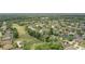 Community aerial view featuring lush landscaping, golf course and many residential homes at 212 Hazeltine Dr, Debary, FL 32713