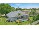 Aerial view of a home with a screened-in pool, large backyard, and lush landscaping at 212 Hazeltine Dr, Debary, FL 32713