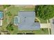 Birds eye view of the home highlighting the roof, screened pool, and surrounding greenery at 212 Hazeltine Dr, Debary, FL 32713
