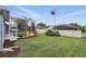 Exterior shot of the backyard including a pool with screened enclosure and well-maintained lawn at 212 Hazeltine Dr, Debary, FL 32713