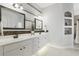 Modern bathroom with double vanity, framed mirrors, and decorative lighting at 212 Hazeltine Dr, Debary, FL 32713