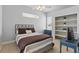 Bedroom featuring a comfortable bed, bookshelves, a desk, and plenty of natural light at 212 Hazeltine Dr, Debary, FL 32713
